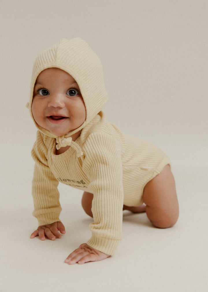 Baby wearing butter ribbed bodysuit