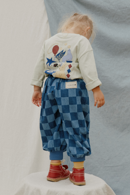 Child wearing blue checkerboard Murphy trousers